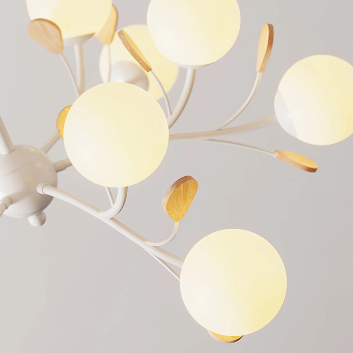 Birdle Branch Chandelier metal framework detail with white branches and wood leaf decorations illuminated