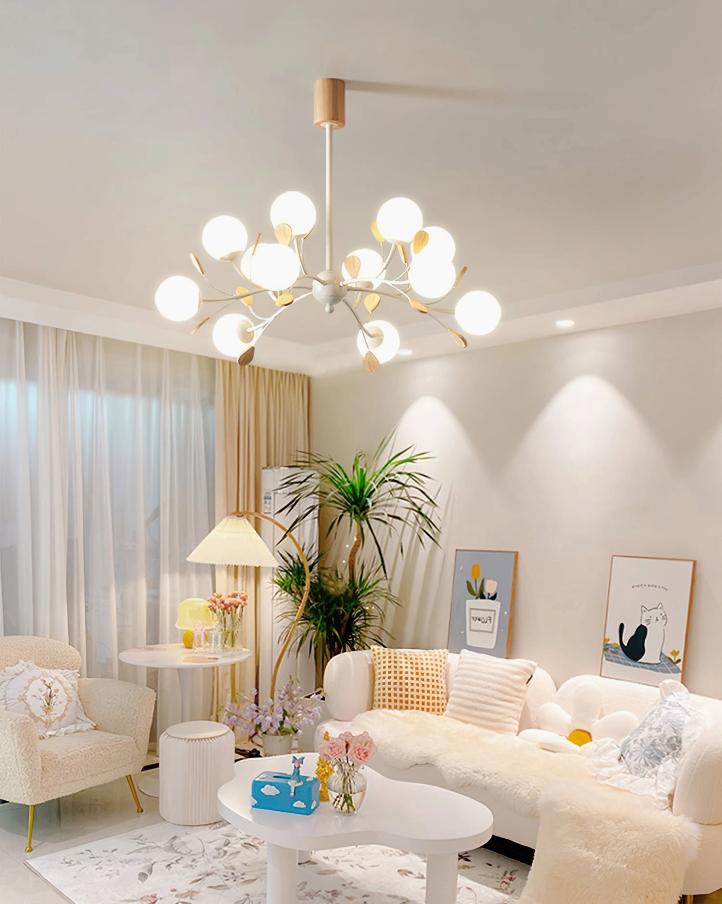 Birdle Chandelier illuminated in cozy modern living room with sofa and warm neutral home décor