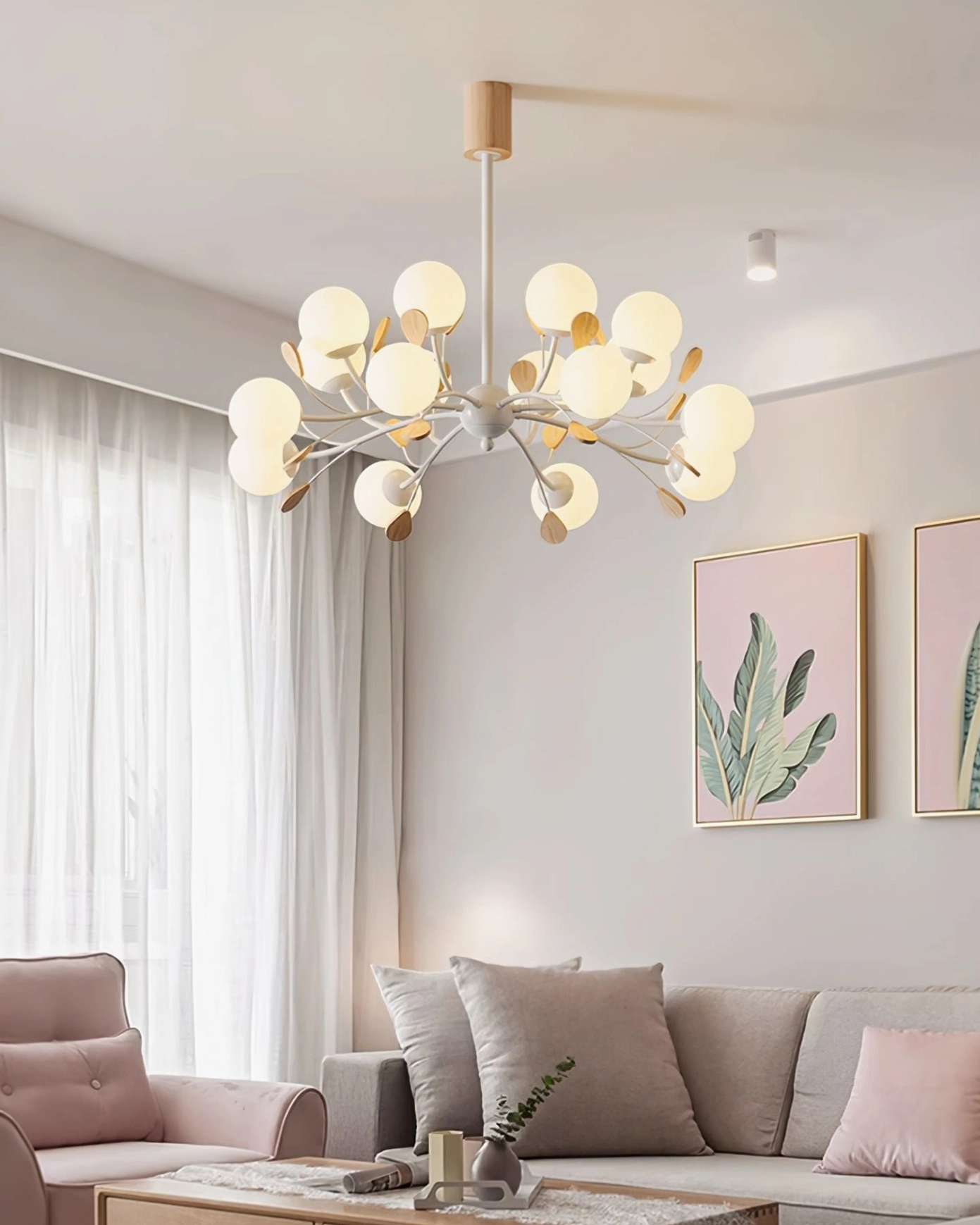 Birdle Branch Chandelier suspended above seating area in modern living room with light palette and wall art