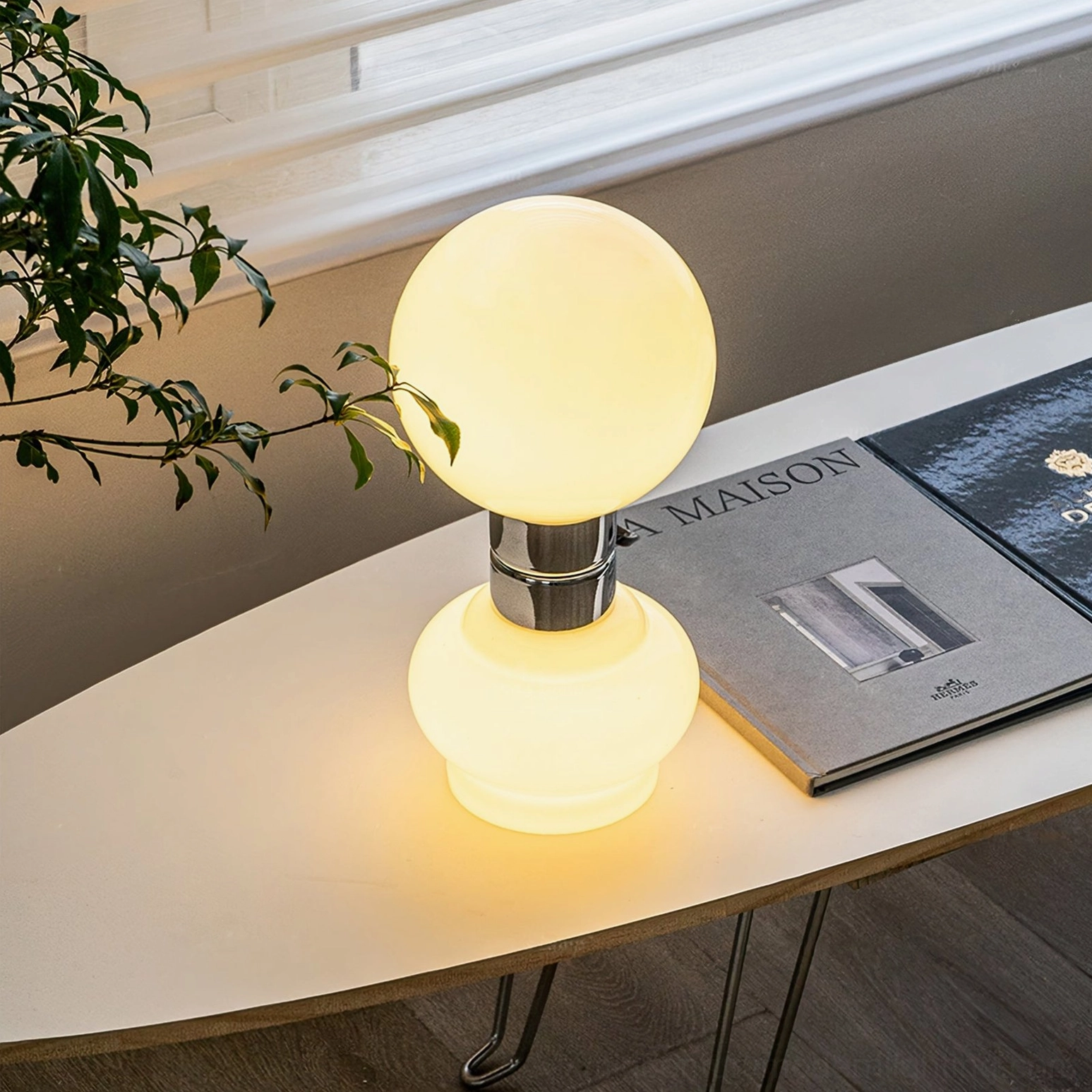 Birillo table lamp lit warm glow interior design books desk ambient lighting