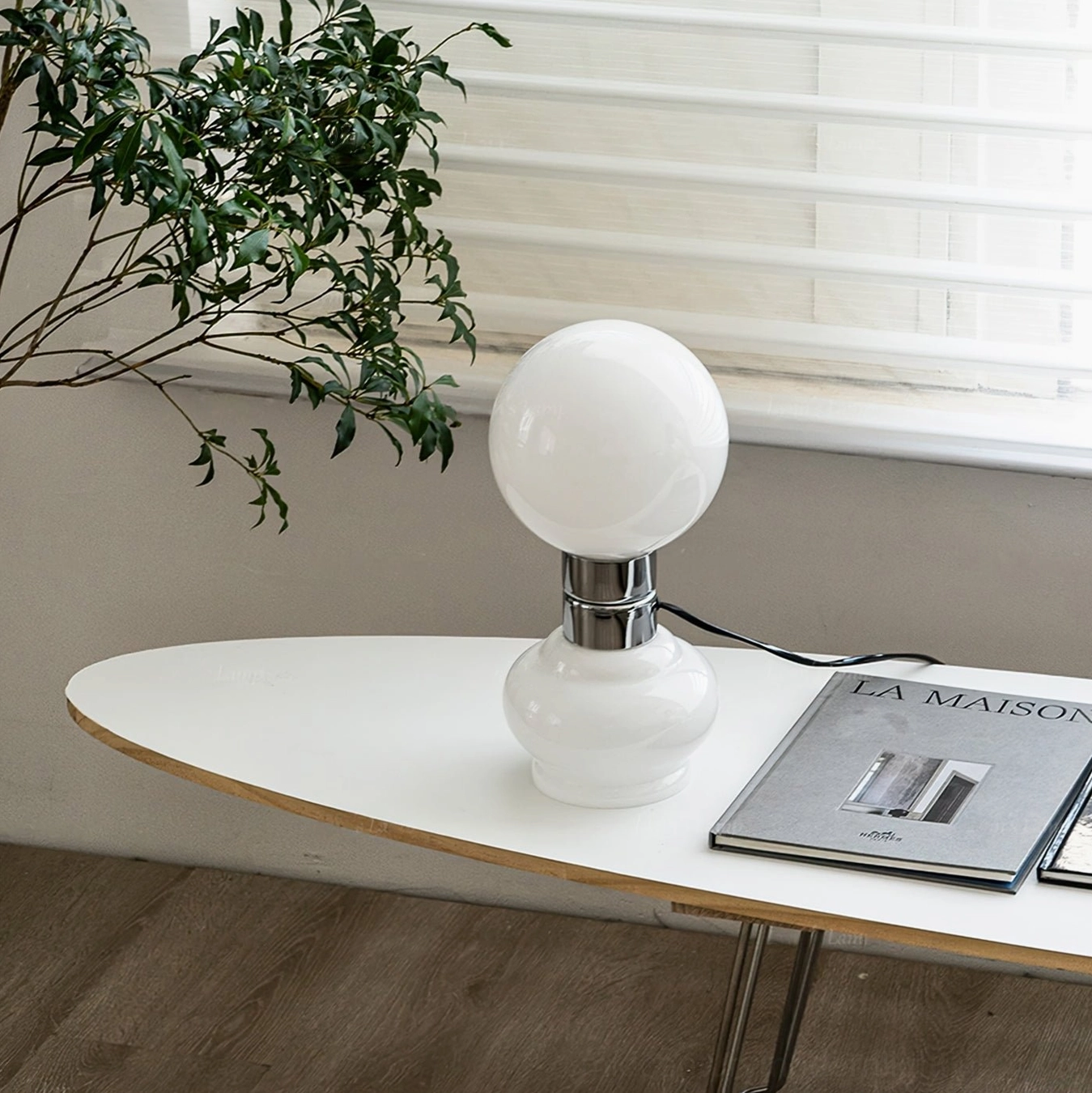 Birillo table lamp three-quarter view wooden desk sunlit window natural light