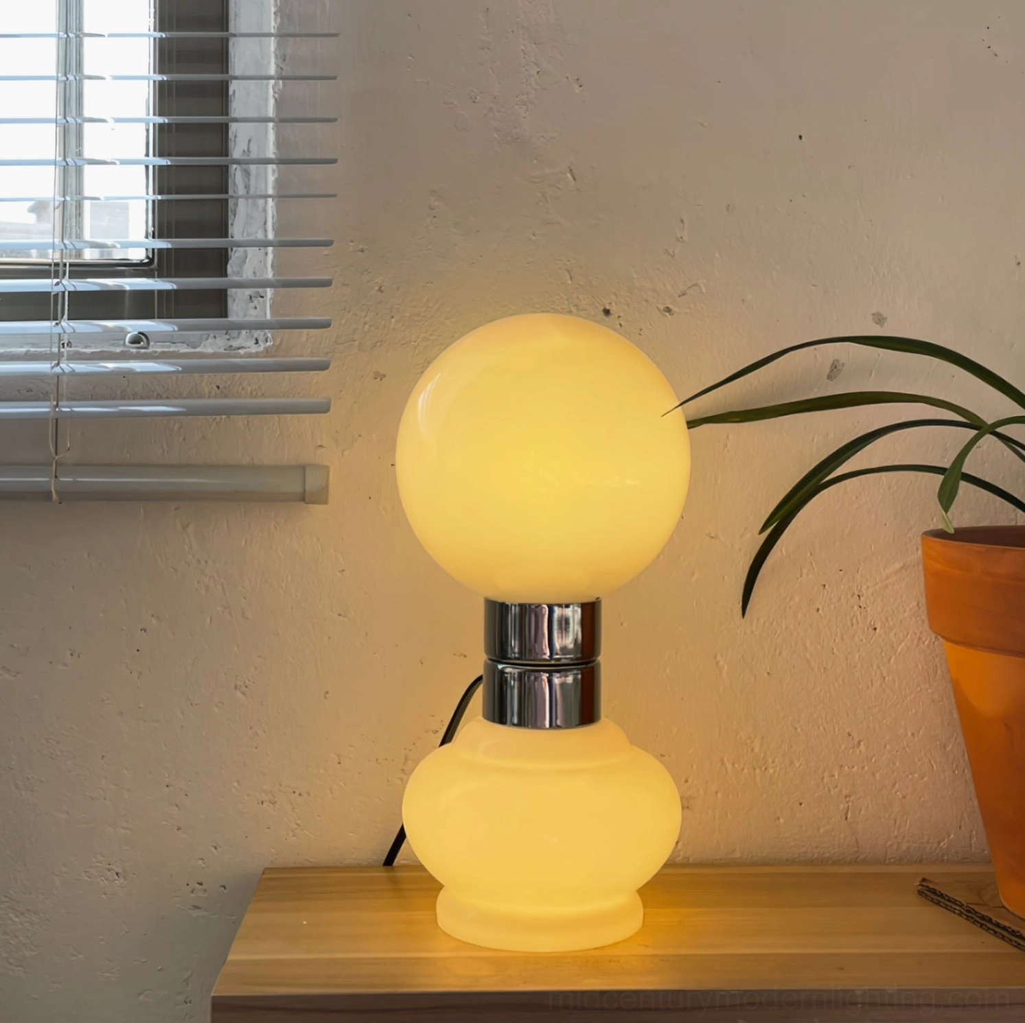 Birillo modern table lamp side angle view white glass polished chrome finish