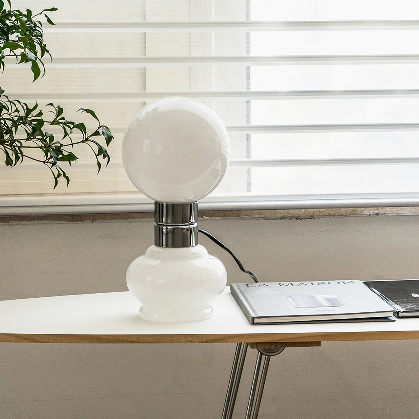 Birillo table lamp on nordic minimalist windowsill desk with green plant
