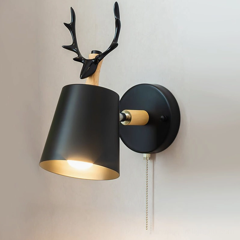 Black antler wall lamp with pull-chain zipper switch, front view showing matte black shade and warm interior light