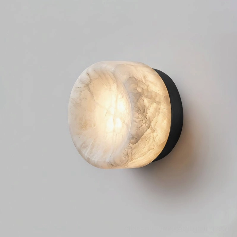 White alabaster and black metal sconce in powder room vanity lighting creating soft diffused glow