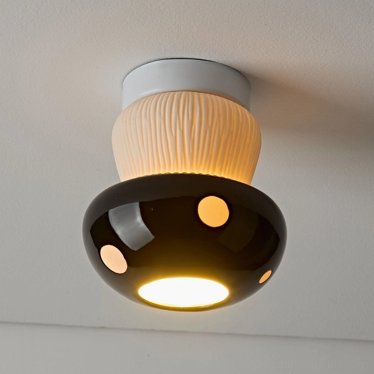 Black mushroom ceiling light overhead close-up with textured beige stem and glossy black cap
