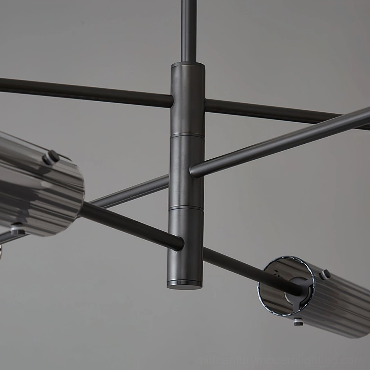 Black chandelier frame joint close-up detail matte black tubular metal arm