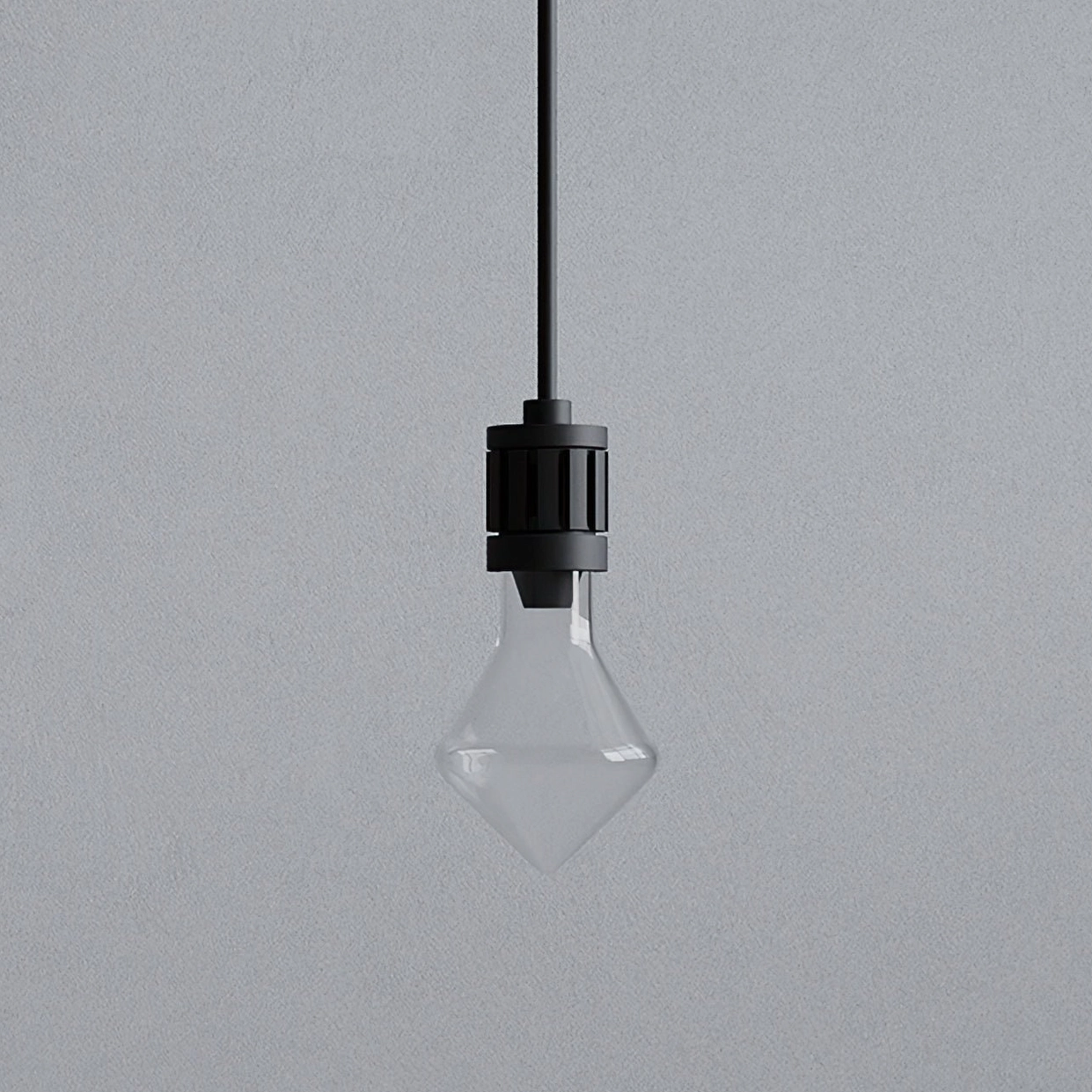 Front-facing close-up detail of black metal diamond pendant lamp fixture showing geometric glass shade construction