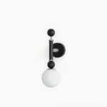 Sculptural globe wall sconce with matte black frame and frosted glass shade on white background, front studio view
