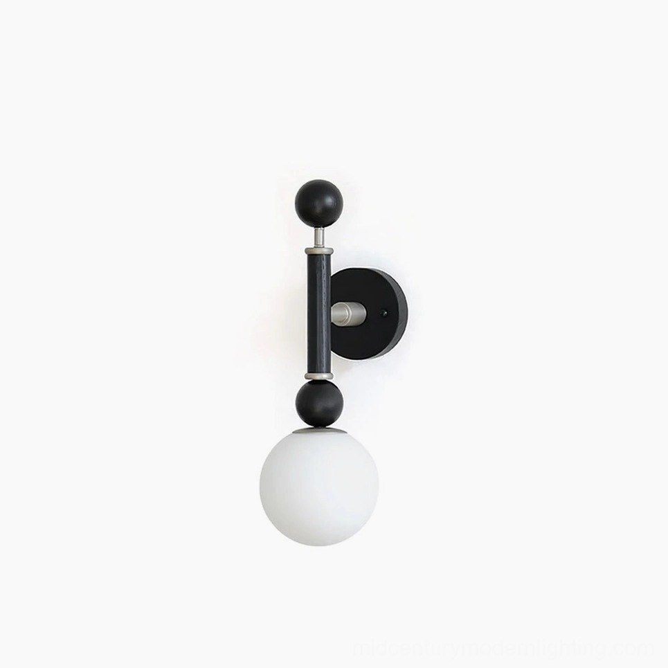 Sculptural globe wall sconce with matte black frame and frosted glass shade on white background, front studio view
