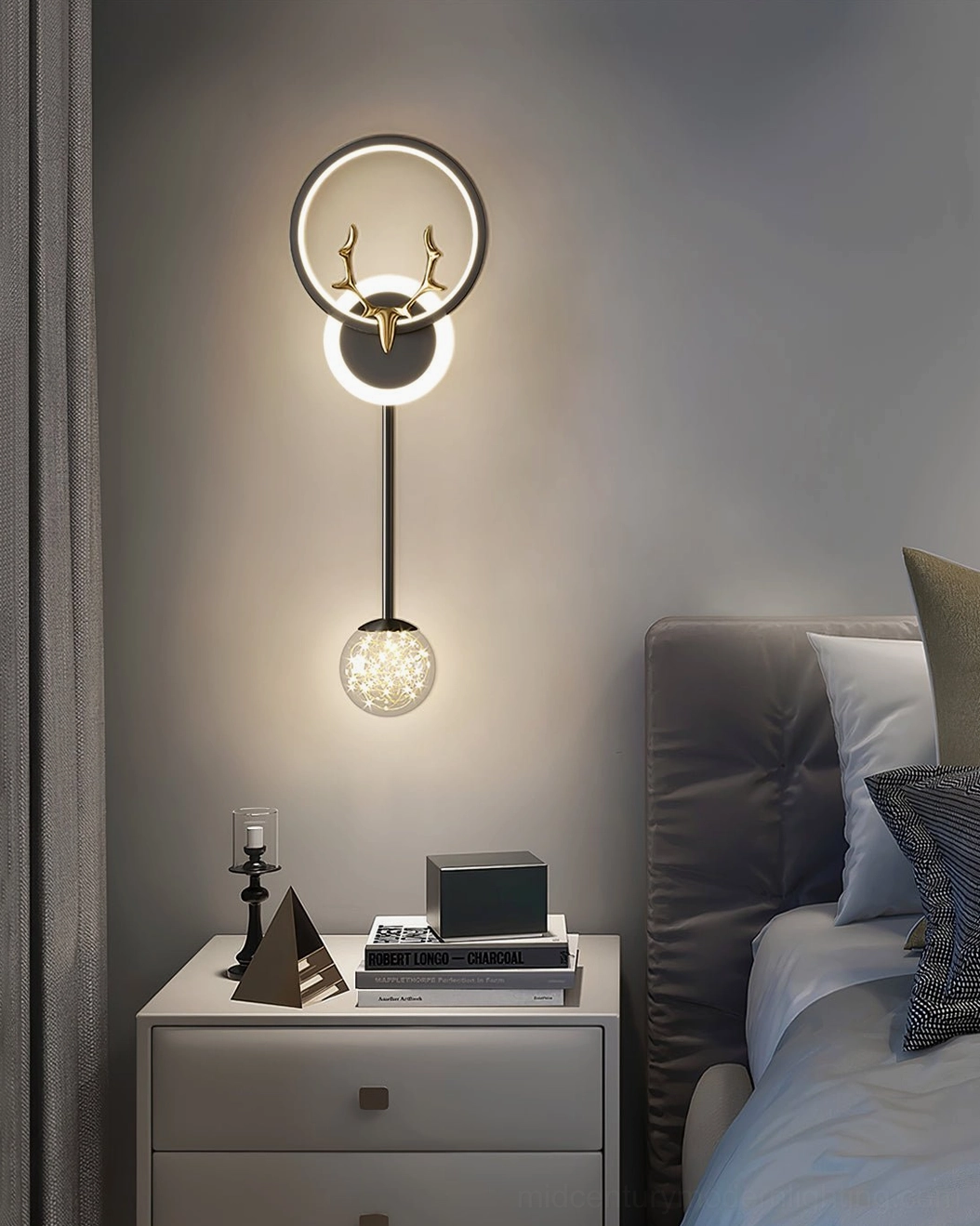 Black and gold two-tone antler wall lamp in master bedroom with sheer curtains and minimalist design