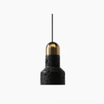 Black hole stone pendant light with brass gold metal cap, front view on white background showing porous volcanic stone texture