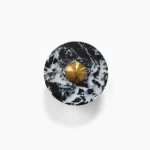 Overhead view of black marble and brass geometric wall lamp showing circular disc design with white veining detail against white background