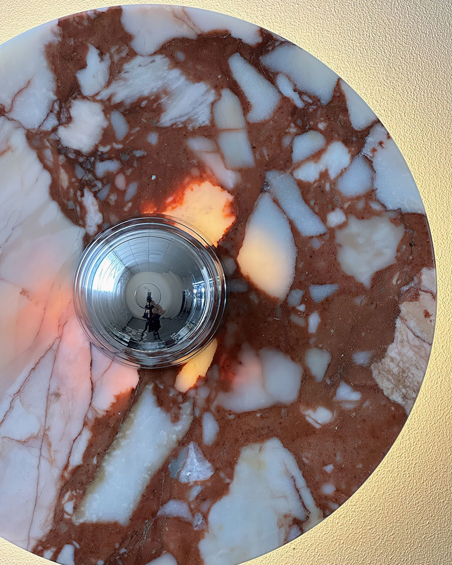 Black marble wall lamp with white veining detail and chrome fixture accent on interior wall mounting