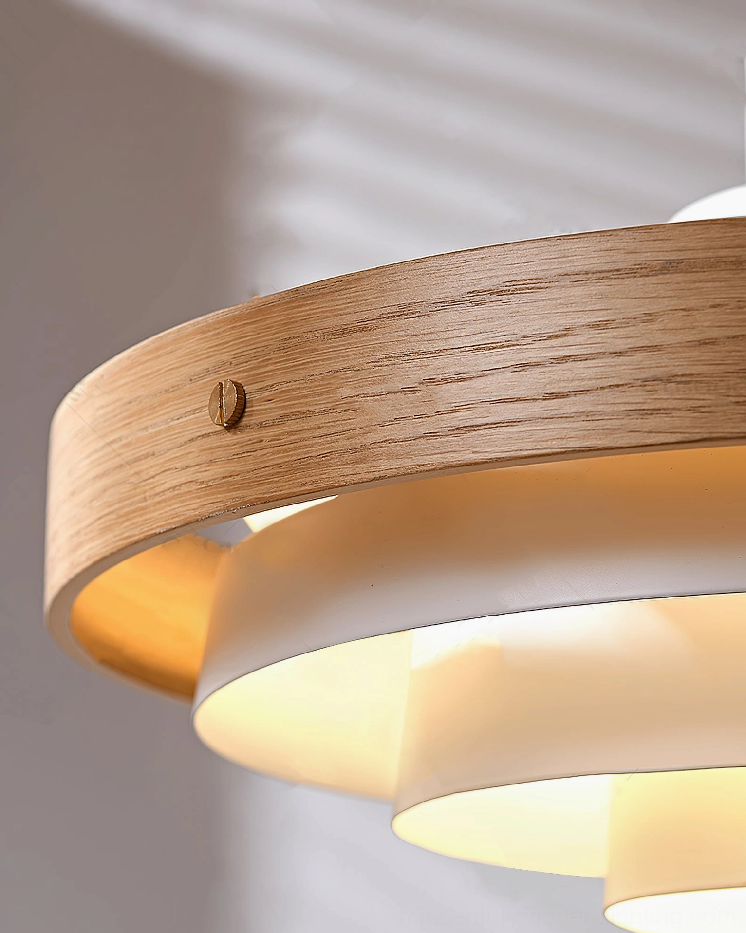 Black metal swing arm with layered wood shade detail in mid-century modern home