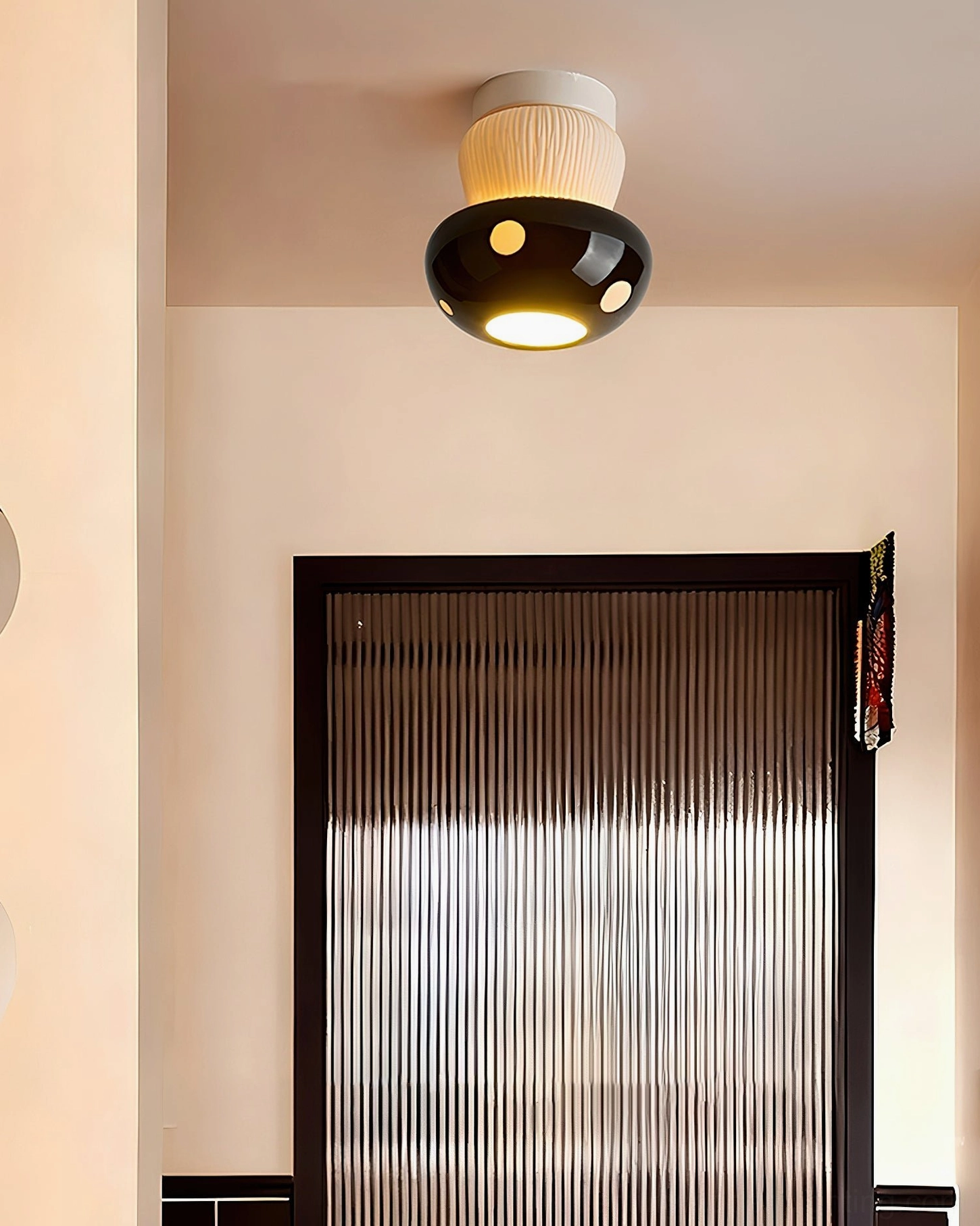 Black mushroom ceiling light installed in modern residential hallway with warm ambient glow