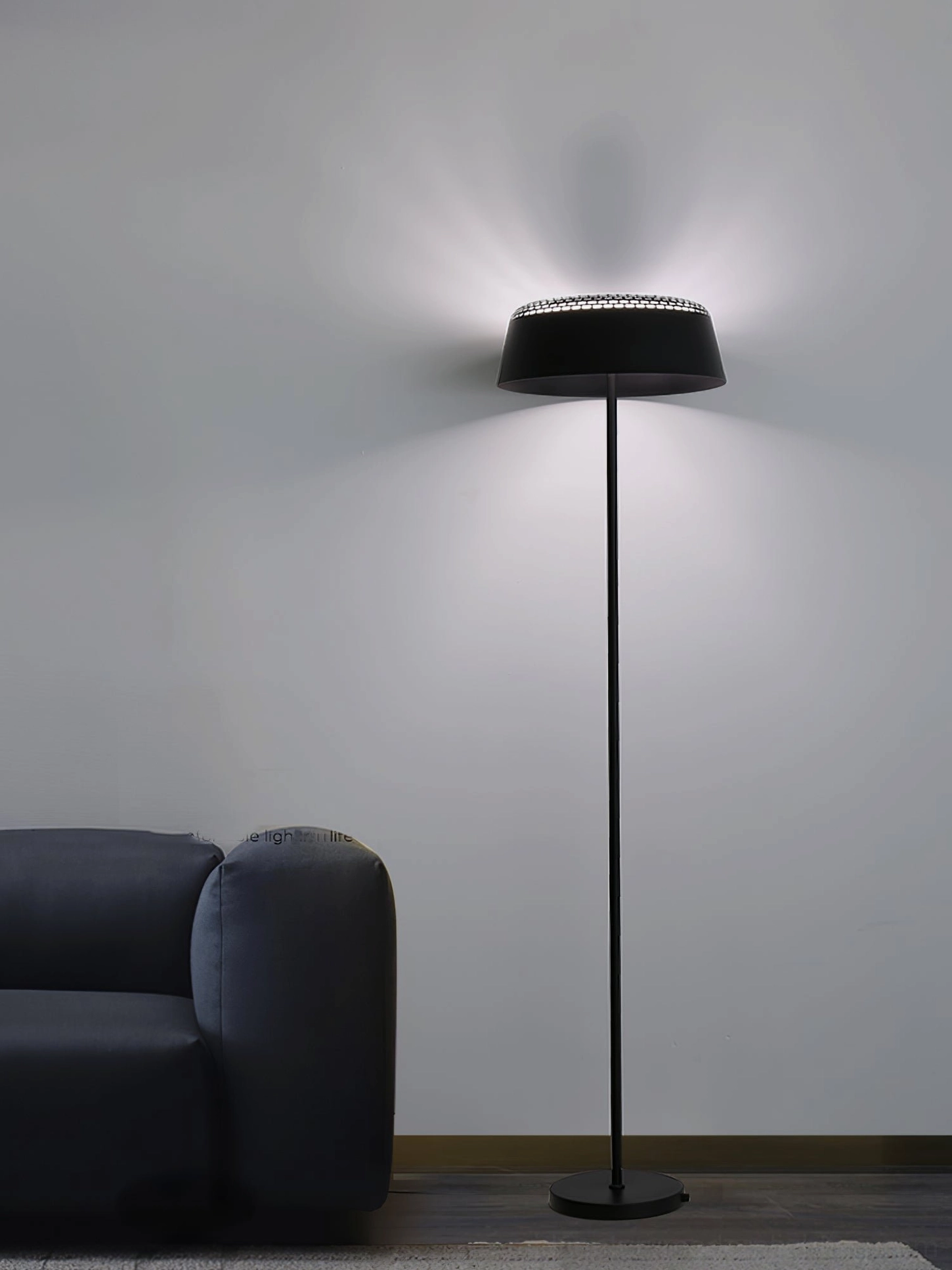 Black ring floor lamp dark sofa modern neutral minimalist decor