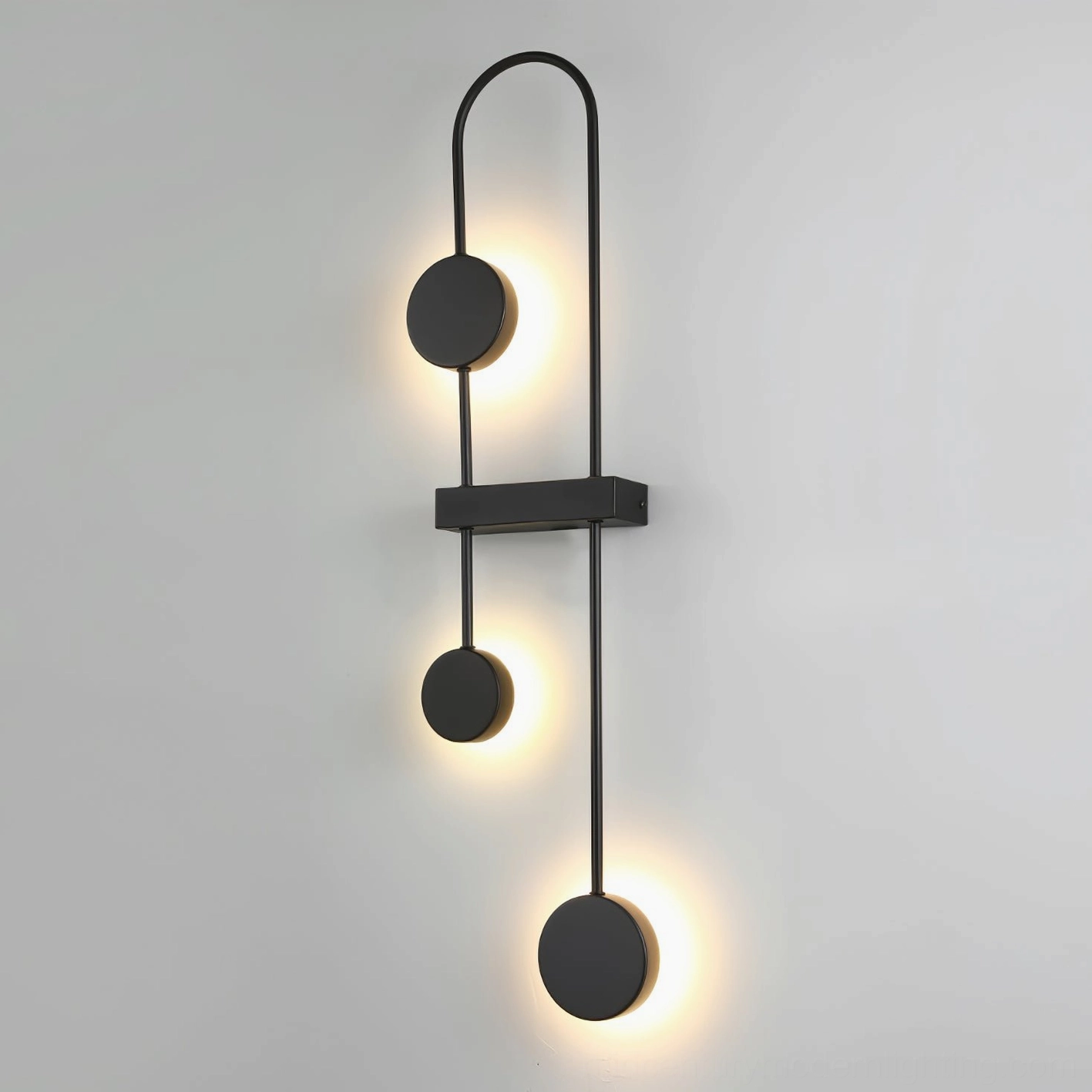 Matte black wall sconce with architectural geometric composition and modern sculptural form