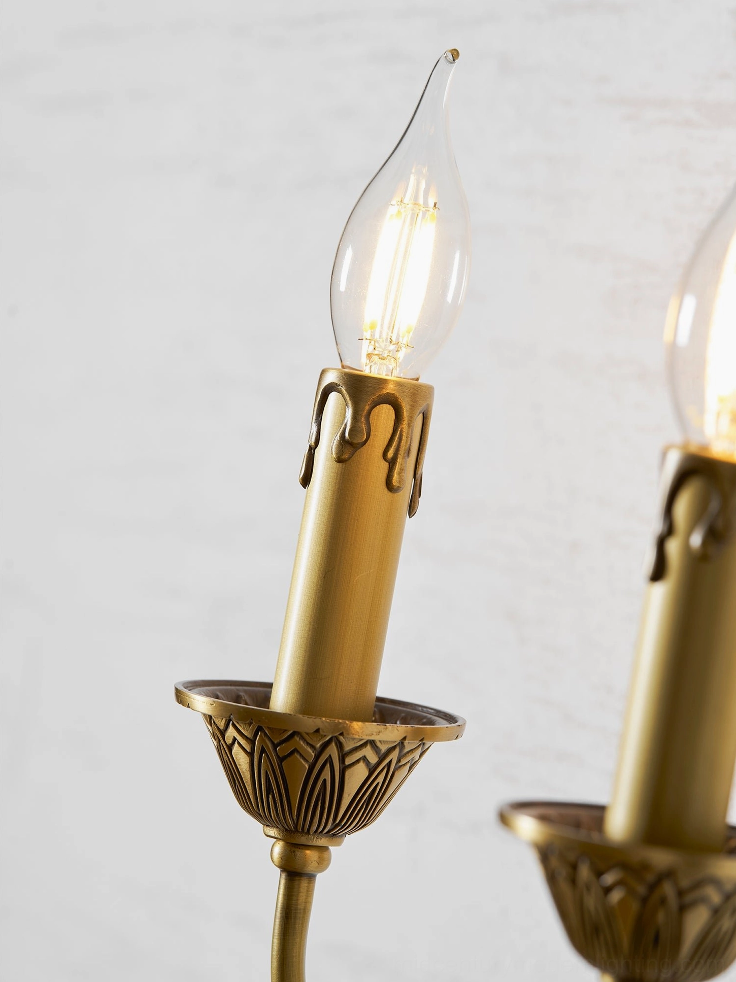 Blair brass candle wall sconce lighting up residential interior space with warm ambient glow