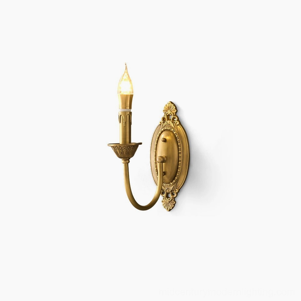 Blair brass candle wall sconce in warm gold finish, front studio view showing sculptural detailing and vintage-inspired candle-style socket