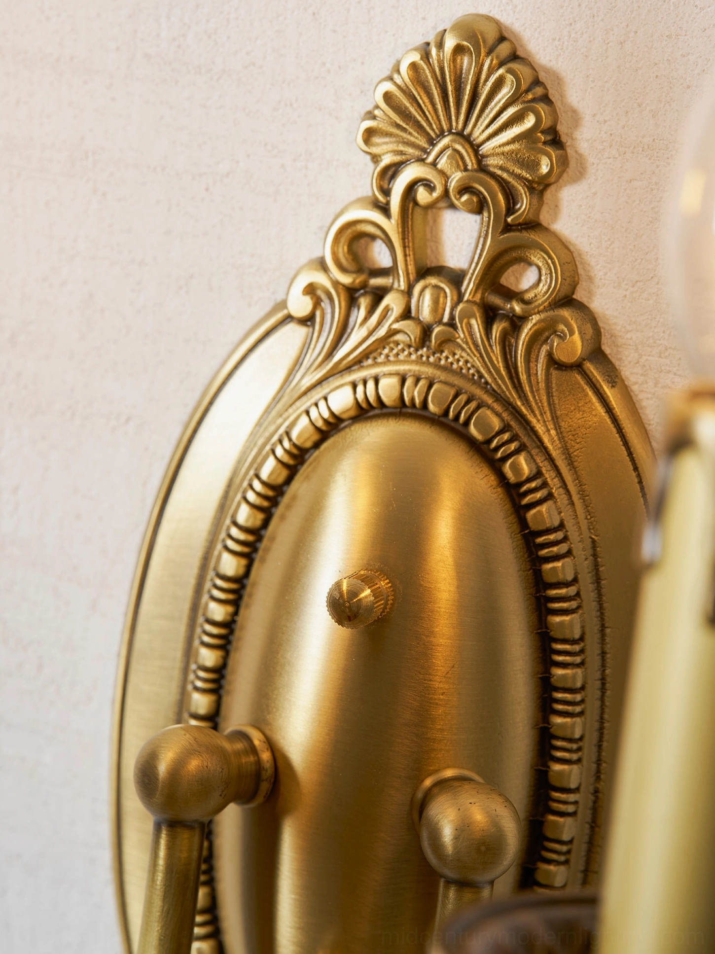 Single Blair brass candle sconce mounted on feature wall showing sculptural brass construction
