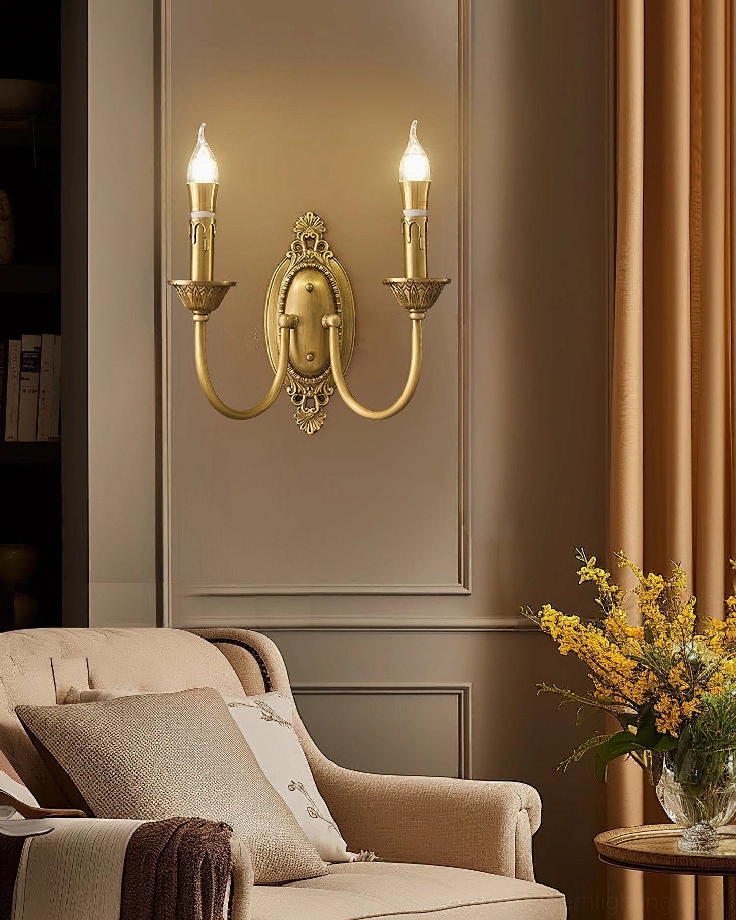 Blair brass candle wall sconce mounted beside bedroom furniture showing soft ambient glow