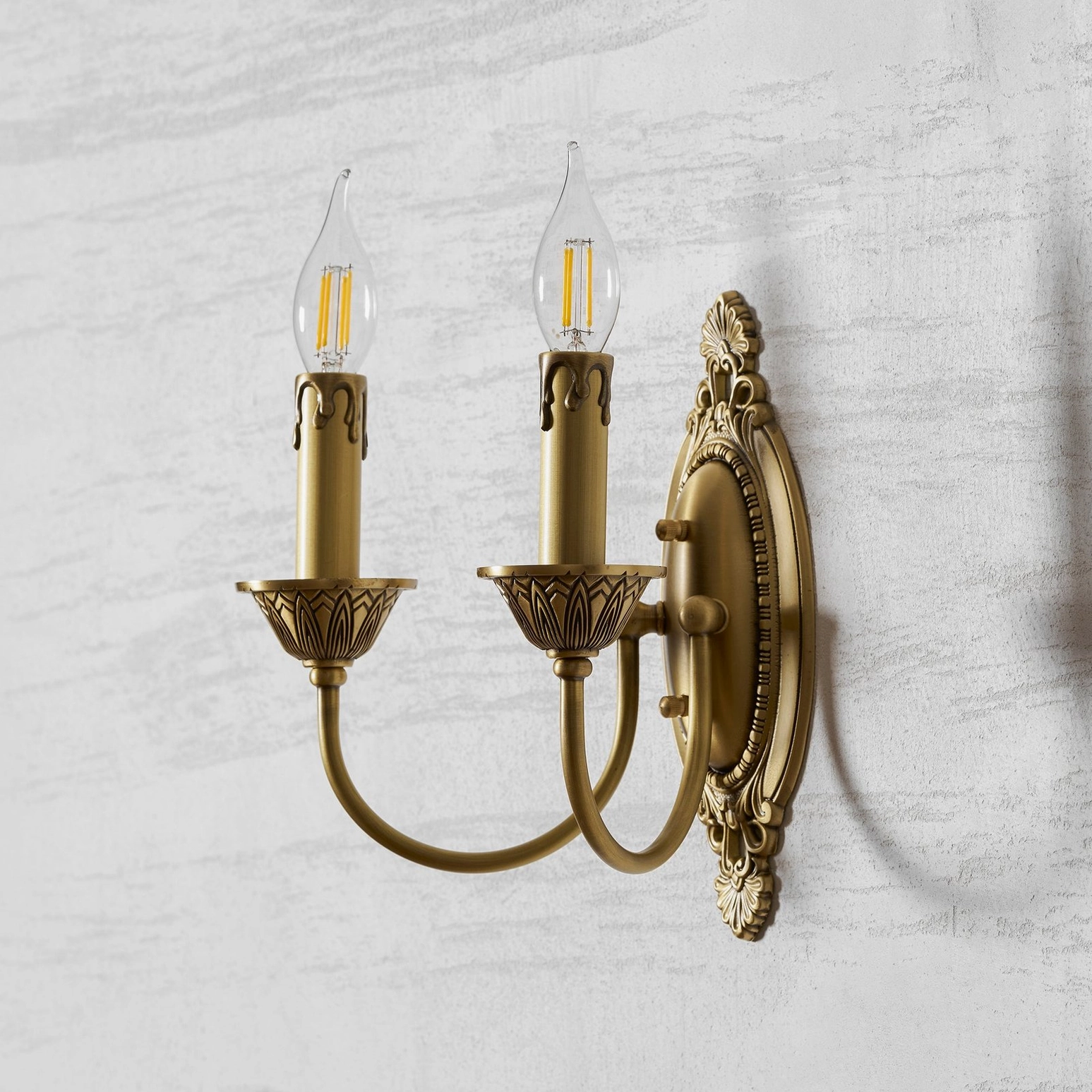 Blair brass candle wall sconce in mid-century modern interior design aesthetic setting