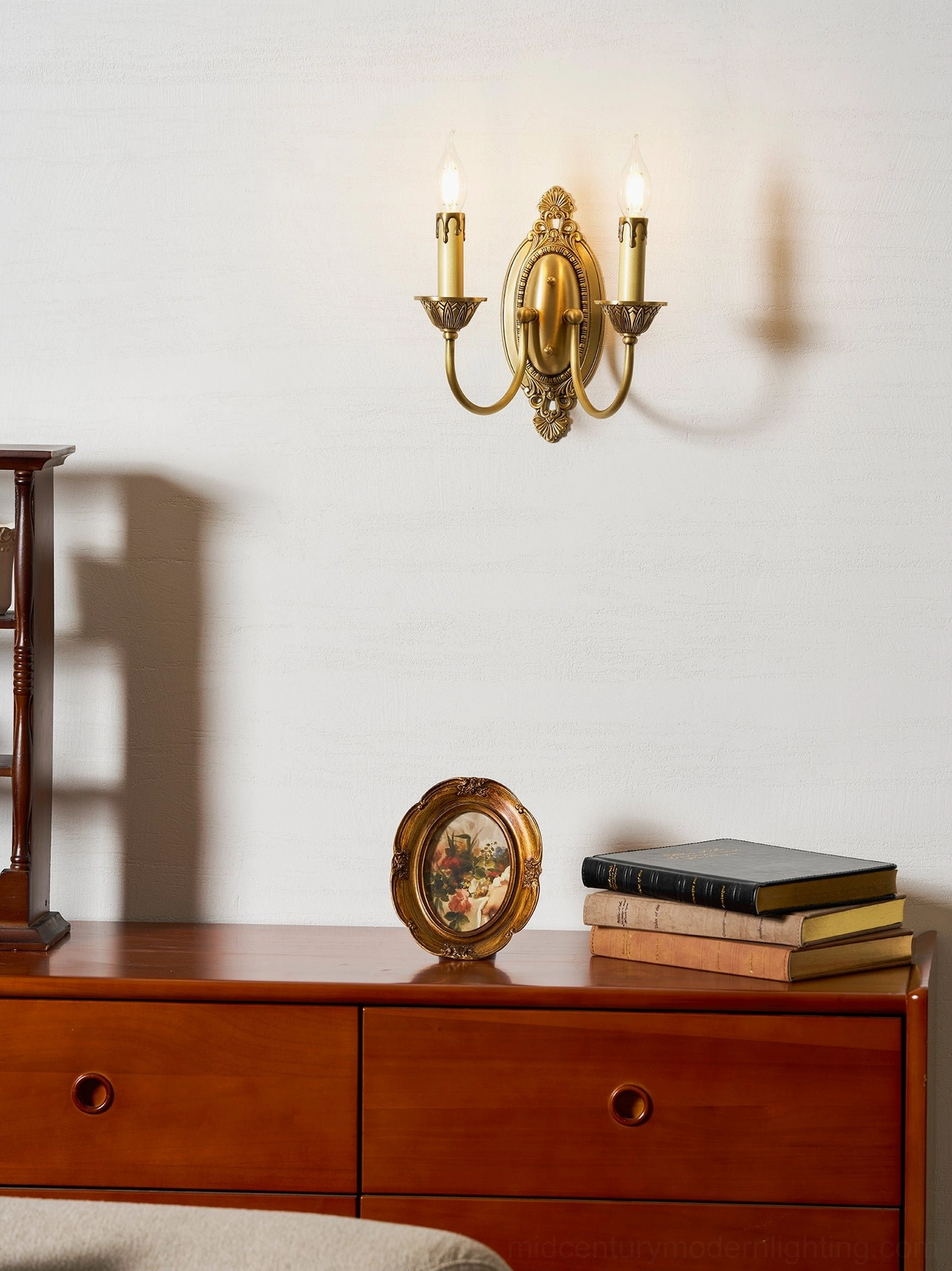 Close-up of Blair brass candle wall sconce showing ornamental brass detailing and socket finish