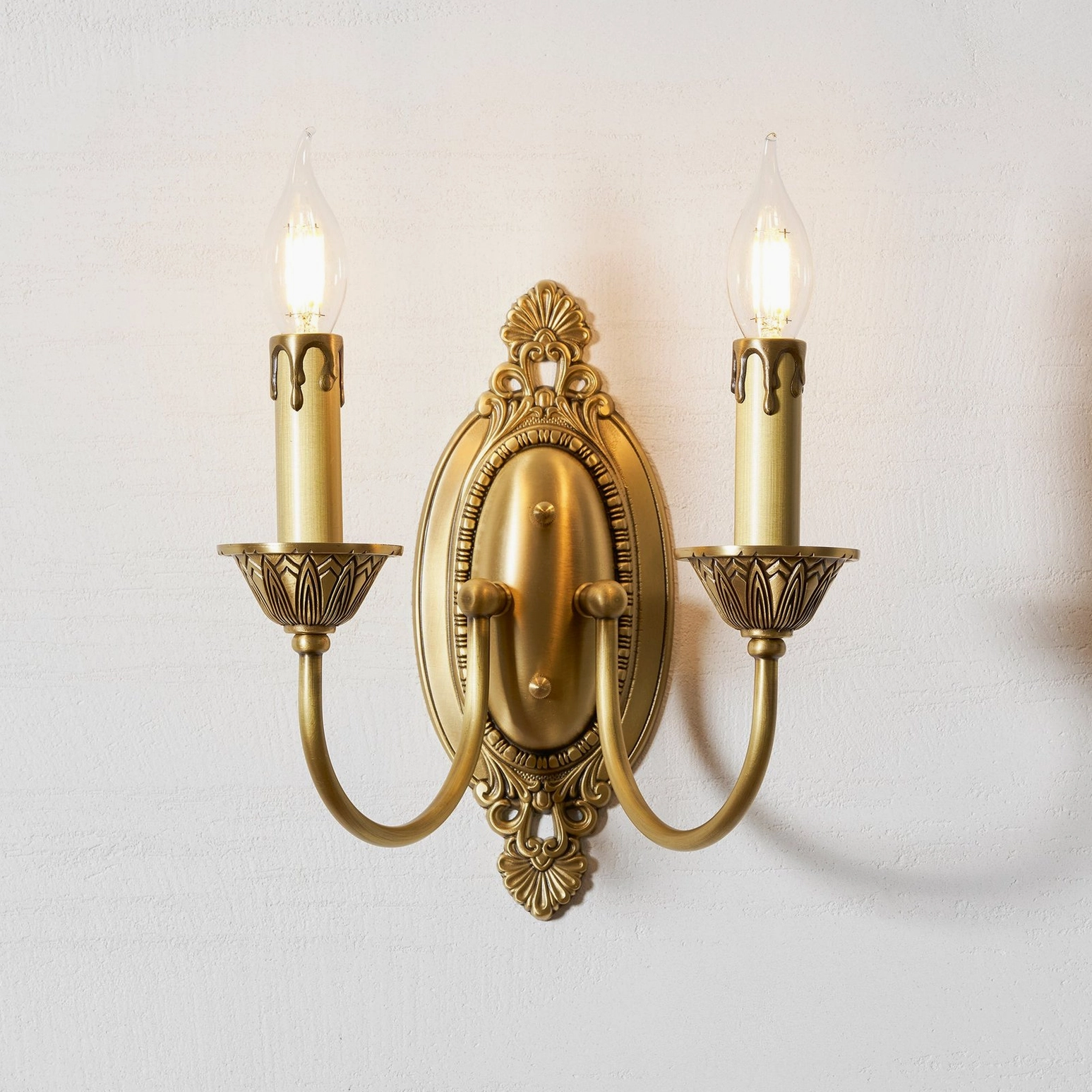Blair brass candle wall sconce showing warm brass patina and vintage-inspired sculptural form