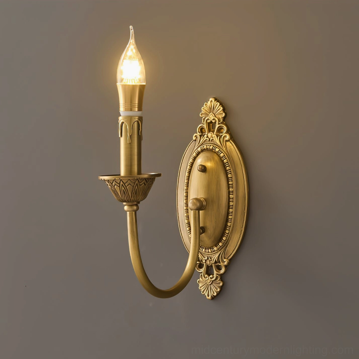 Blair compact brass candle wall sconce in warm gold finish, side profile studio view