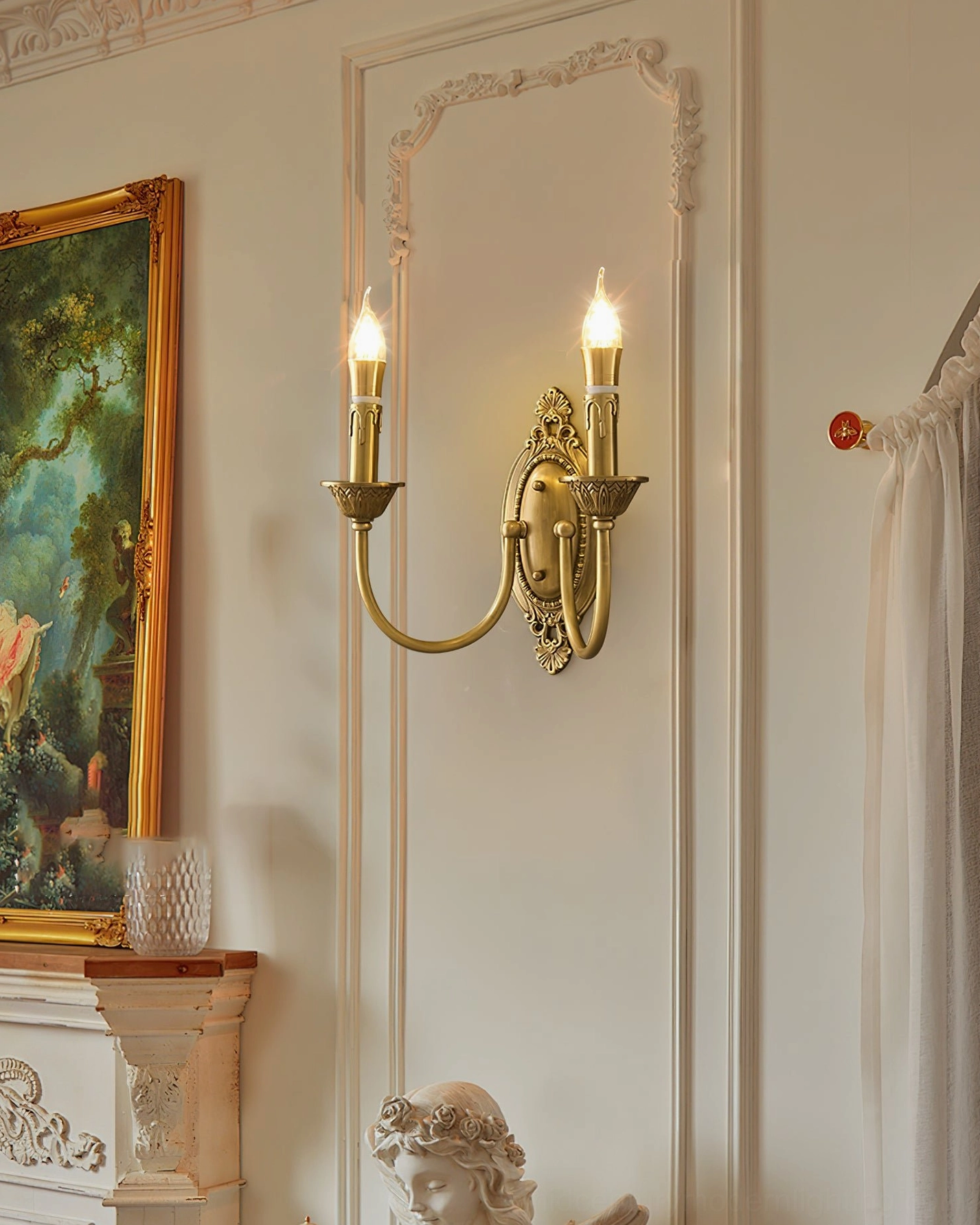 Single-arm Blair brass candle wall sconce in warm gold showing traditional European design influence