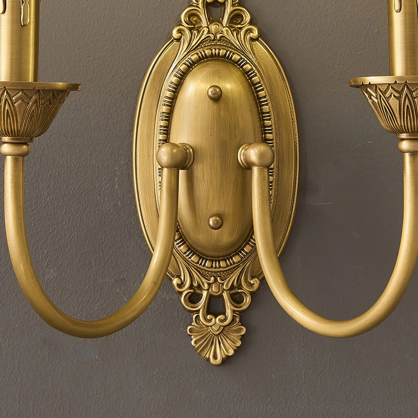 Wide Blair brass candle sconce shown above console table in elegant entryway design