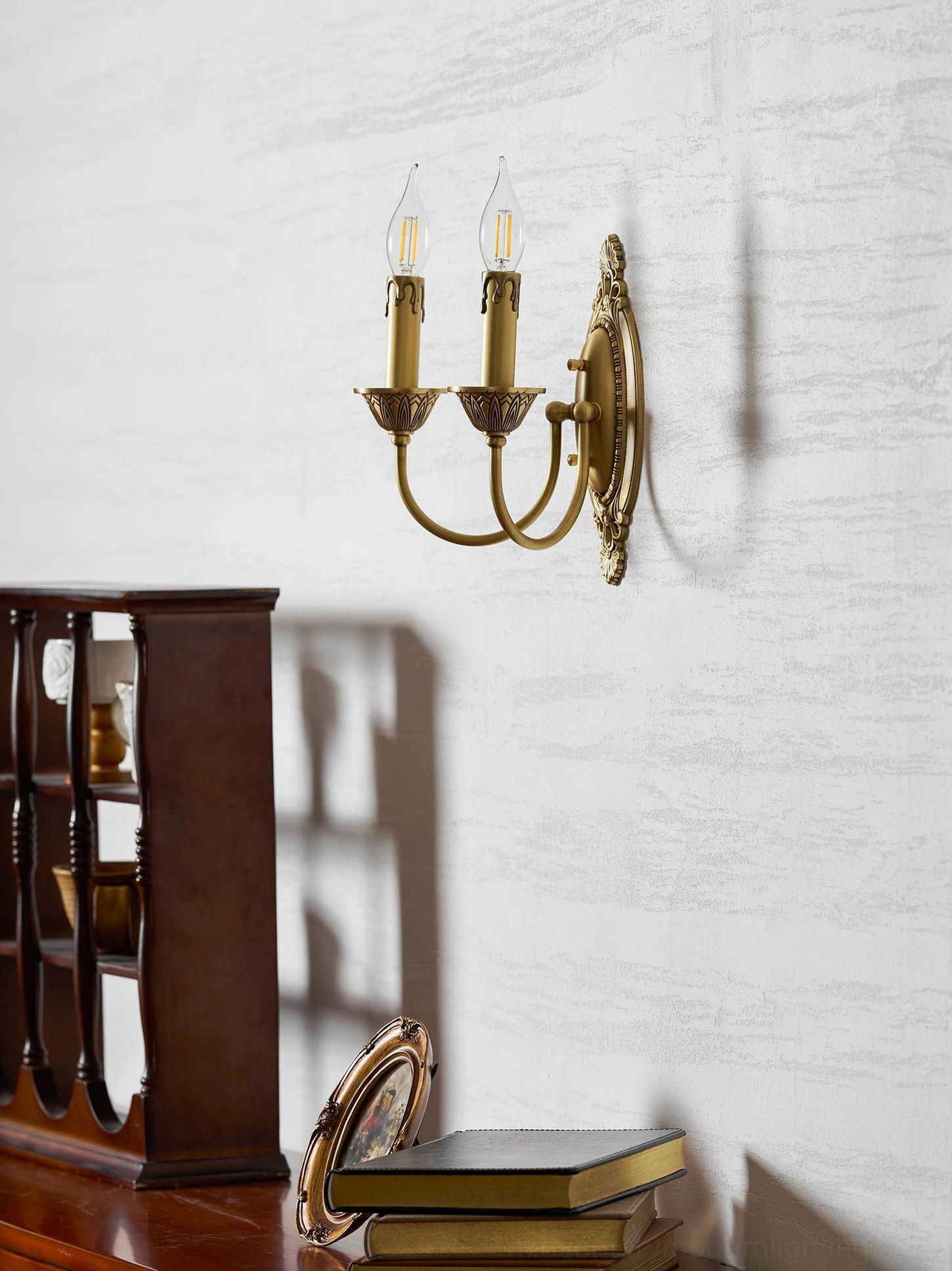 Wide variant Blair brass candle wall sconce in living room showing substantial design presence