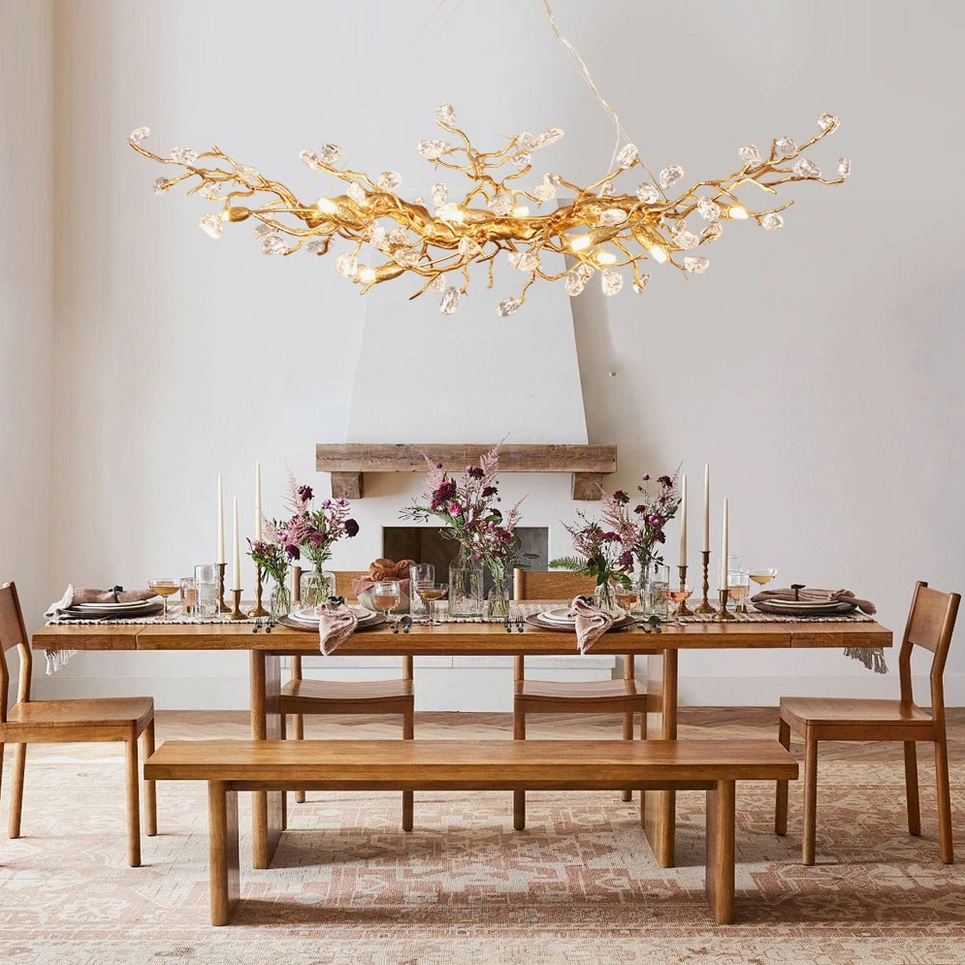 Bloom Branch Chandelier illuminated in elegant dining space with fireplace and traditional furnishings