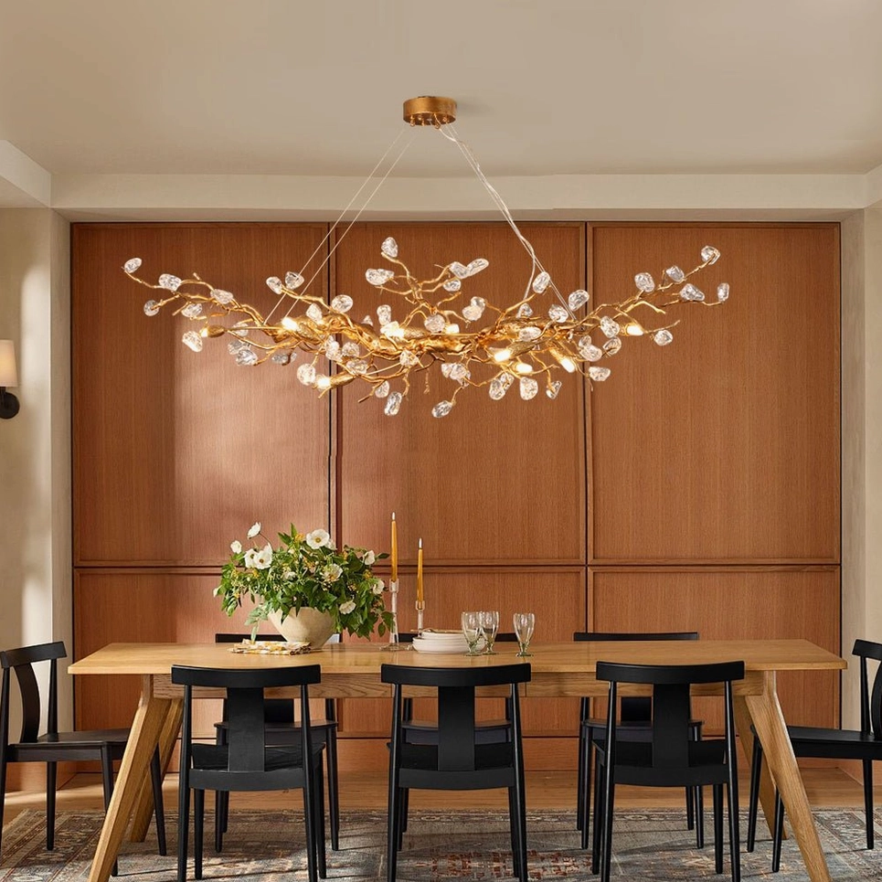 Mid-century modern Bloom Branch Chandelier in rustic dining room with wood panel walls and black chairs