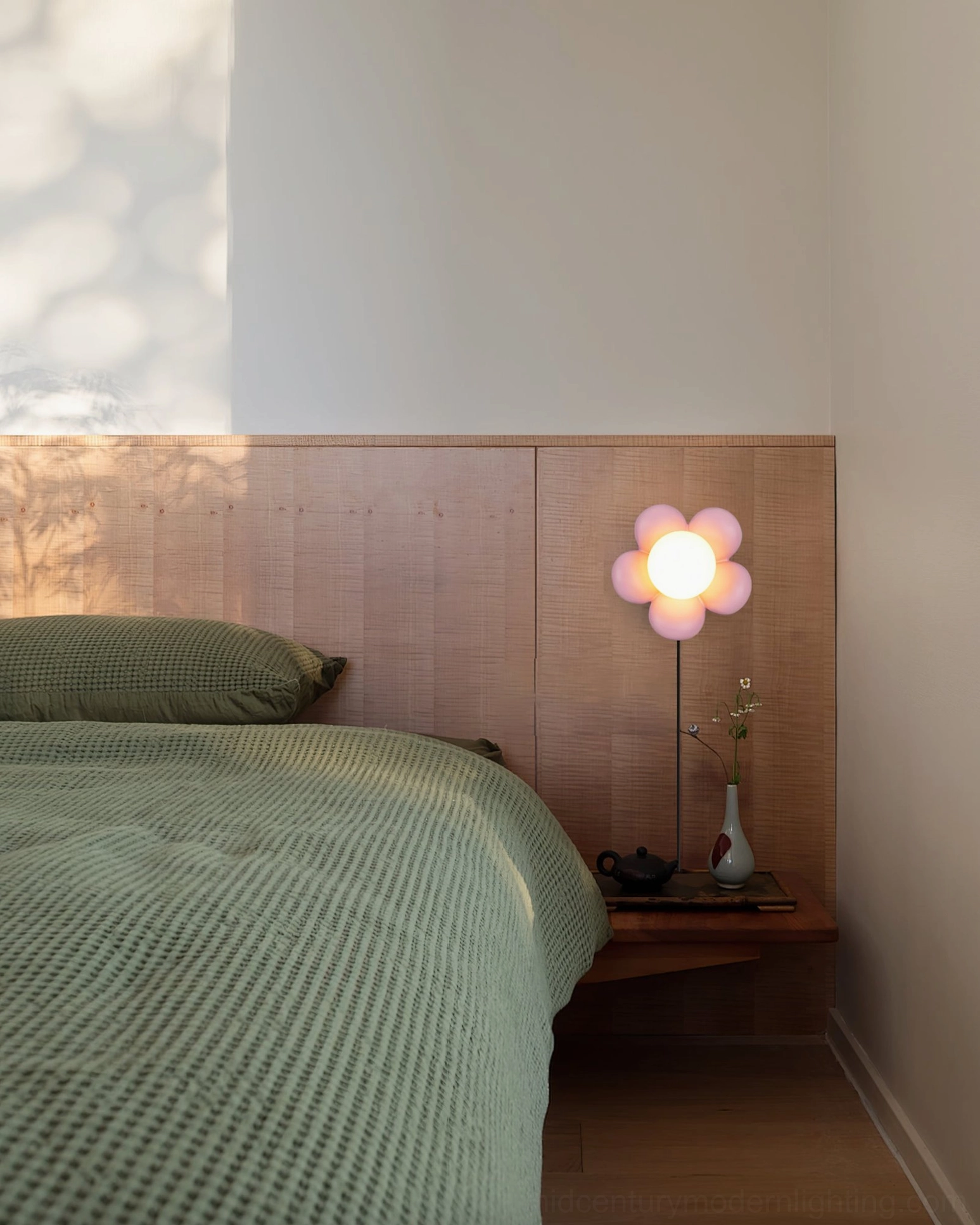 Bloom pink flower bedside wall lamp bedroom wooden headboard glowing warm light green bedding