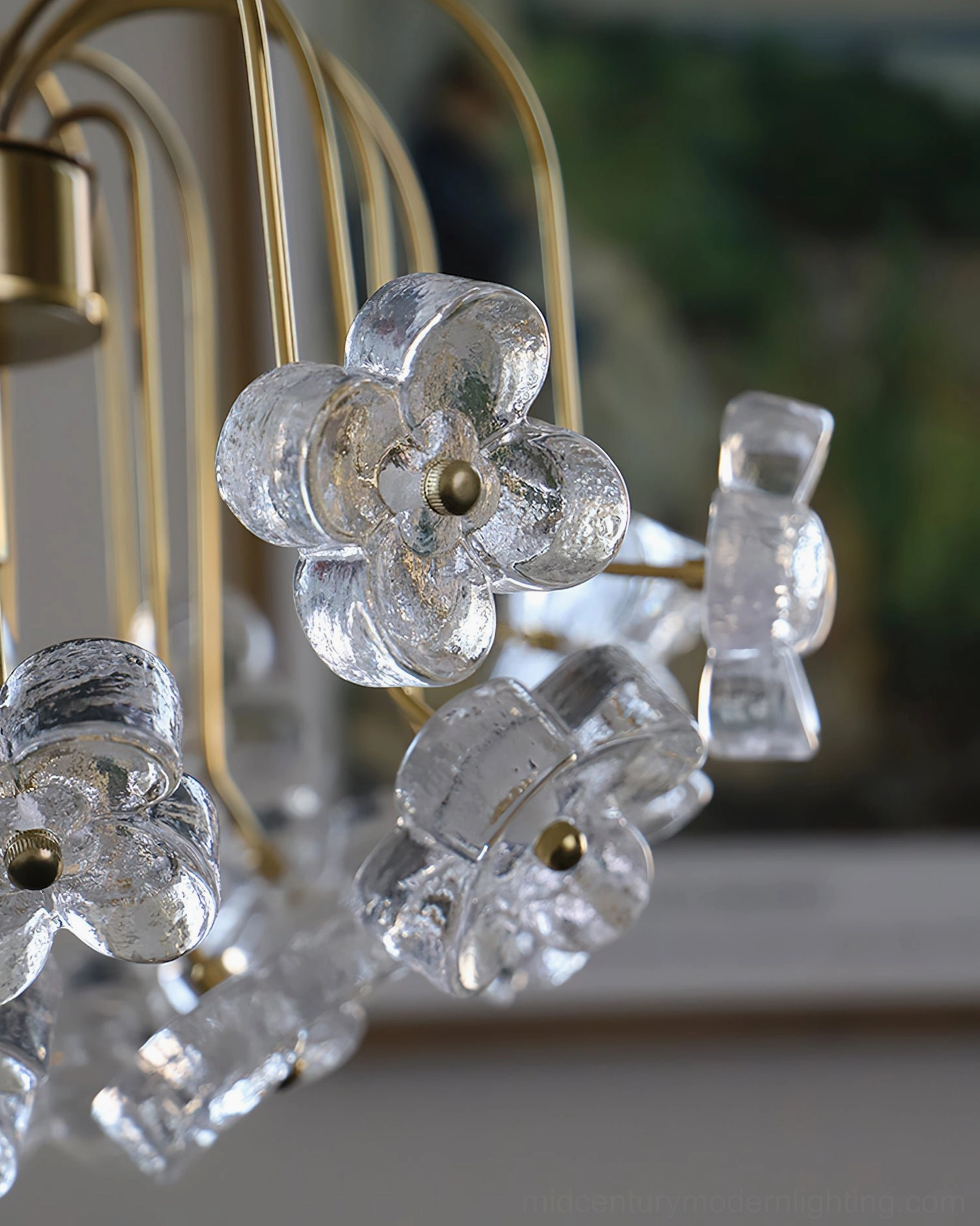 Close-up detail of Blossom pendant light glass flowers and brass metal frame construction