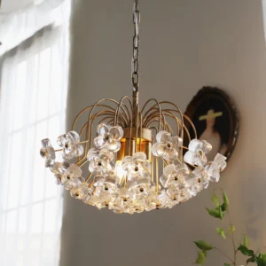 Lit Blossom pendant chandelier illuminating a vintage home interior with green plants and wall art, warm glowing ambiance