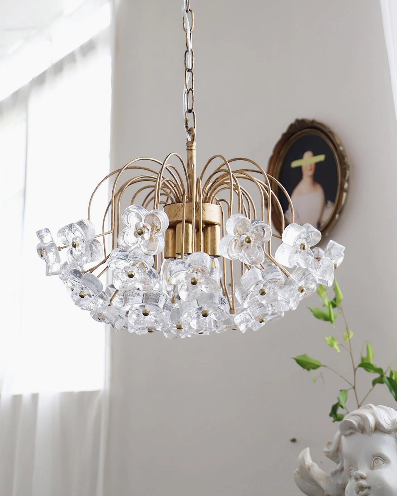 Unlit Blossom pendant chandelier displayed in minimalist luxury vintage interior with sculpture and wall art