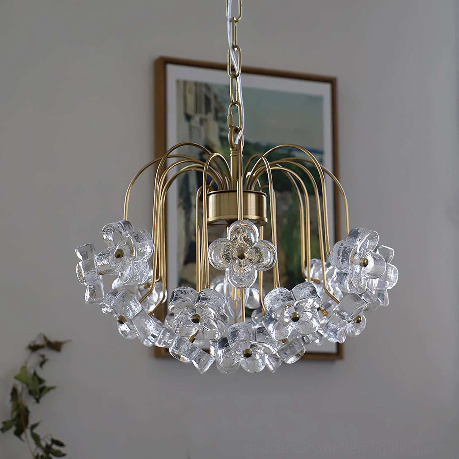 Unlit Blossom crystal pendant light three-quarter view showing brass frame and clear glass flower details in home setting