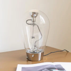 Blow table lamp three-quarter view on minimalist office desk with magazine and black power cord - mid-century modern lighting