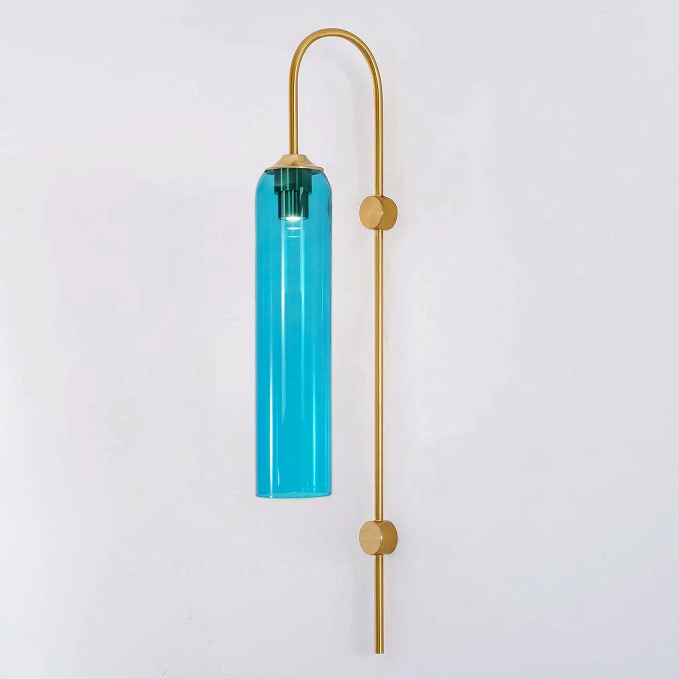 Blue glass cylindrical wall sconce with gold metal frame in elegant interior setting