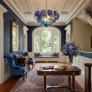 Blue gradient marble-swirl glass chandelier suspended in formal French living room with dark wood furniture and blue floral decor