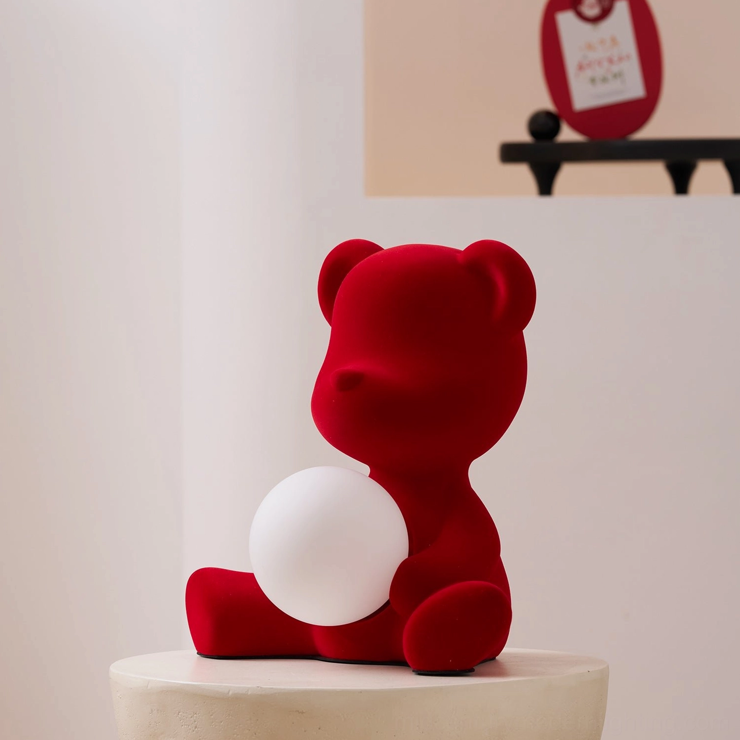 Blue teddy bear table lamp glowing on display surface with warm interior illumination