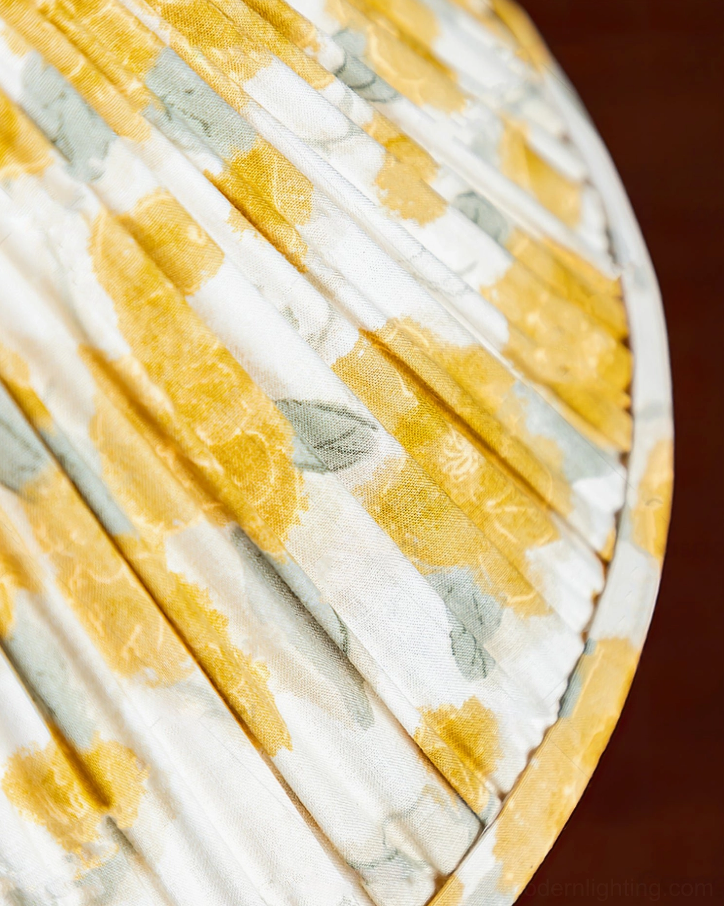 Top-down close-up of Bobbin table lamp pleated fabric shade with yellow-grey floral print texture