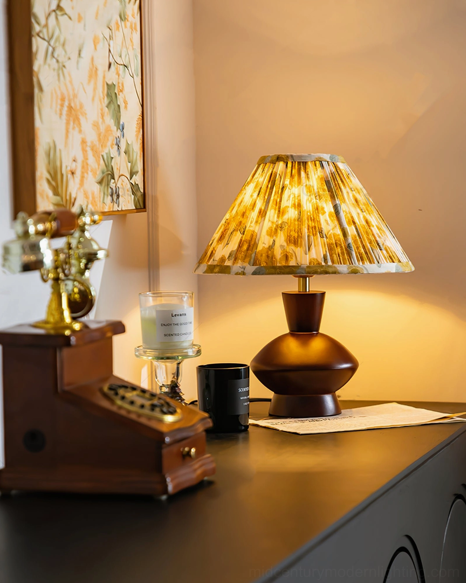 Retro side view of Bobbin pleated fabric table lamp next to vintage telephone and warm home décor