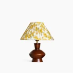 Bobbin mid-century modern table lamp with pleated fabric shade and dark walnut wood base, front studio view