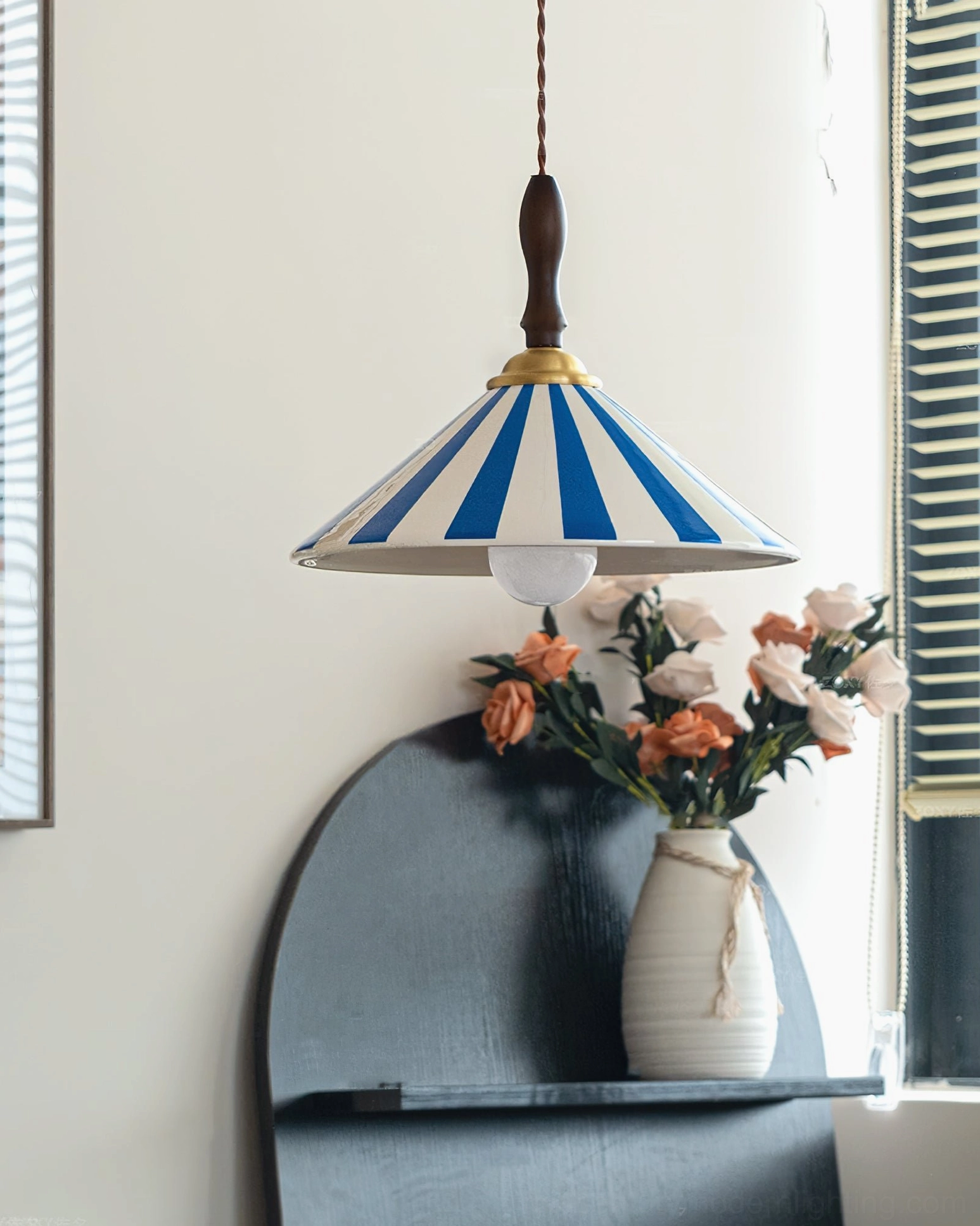 Blue and white striped Bobine ceramic pendant light hanging in sunlit home interior with floral decoration, cottage style