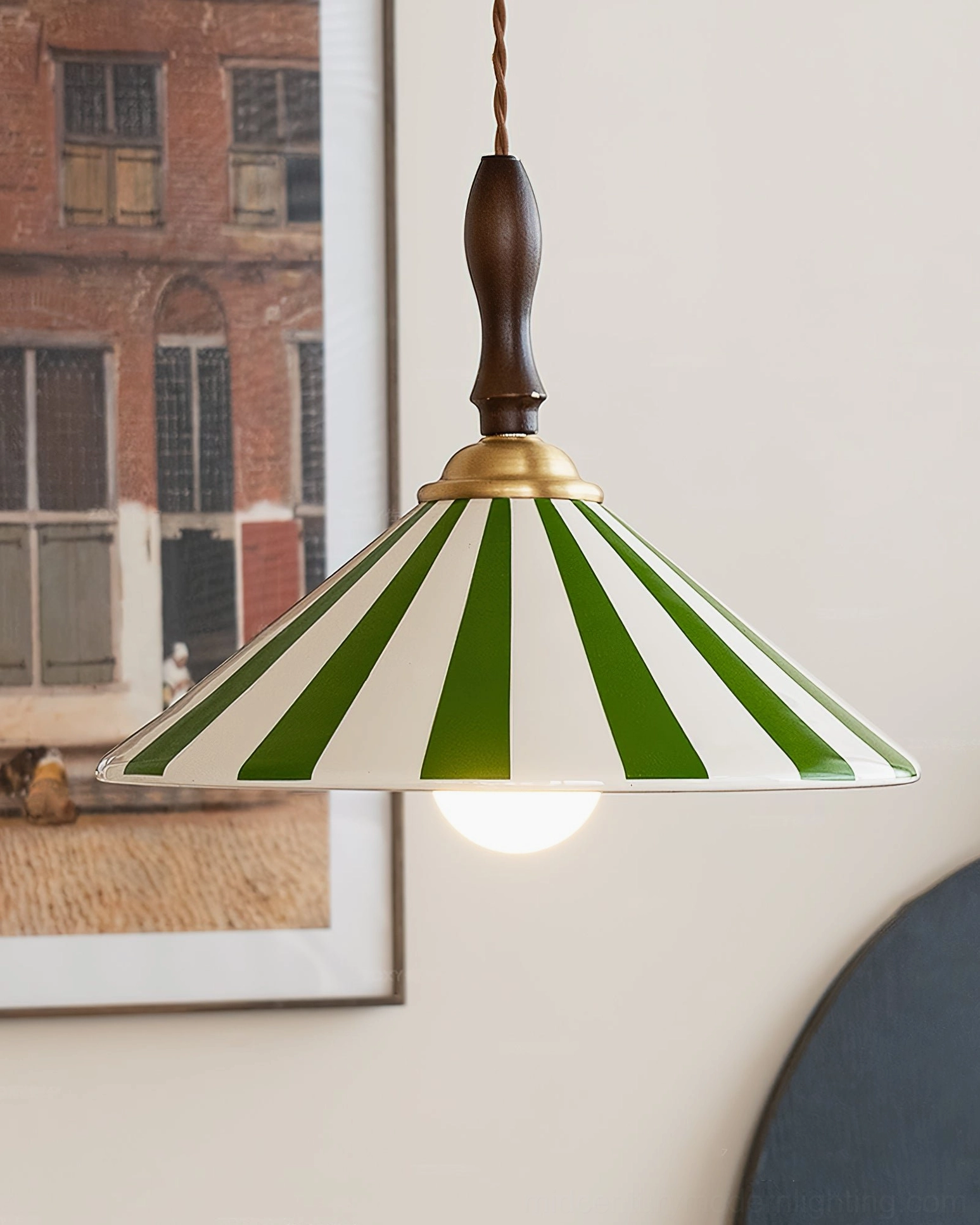 Bobine pendant light with braided suspension cord, low angle view showing brass hardware and ceramic detail