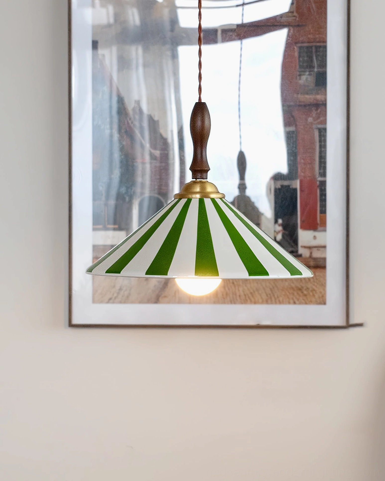 Green and white striped Bobine pendant light with exposed filament bulb, interior home setting with wall art